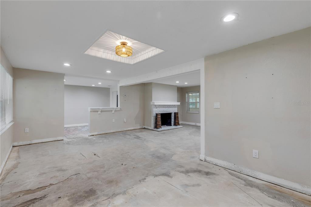 103 Flagler Avenue Edgewater, FL 32132 - Photo 9 of 53 an empty room with windows and fireplace