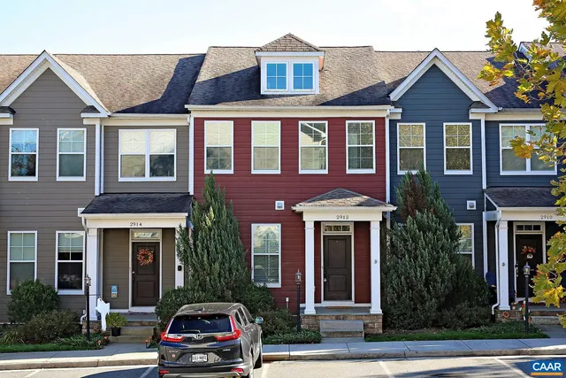 a front view of a residential apartment building with a yard
