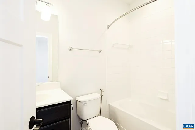 a white toilet sitting next to a bathroom sink