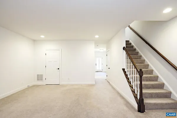 a view of an empty room with stairs