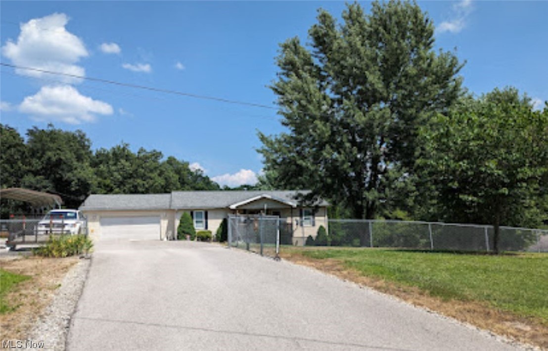 965 Access Road Williamstown, WV 26187 - Photo 2 of 11 Blacktop drive way with chain link fence around part of the yard