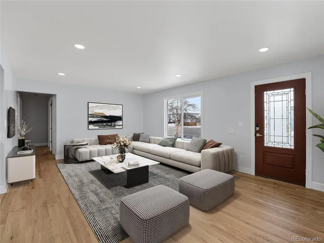 a view of empty room with kitchen and a window