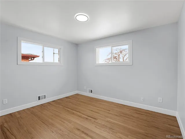 a bedroom with bed and painting on the wall