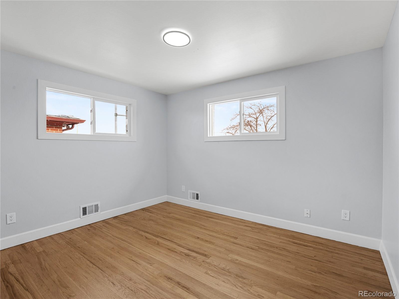 7889 North Pecos Street Denver, CO 80221 - Photo 22 of 42 a view of empty room with wooden floor and fan