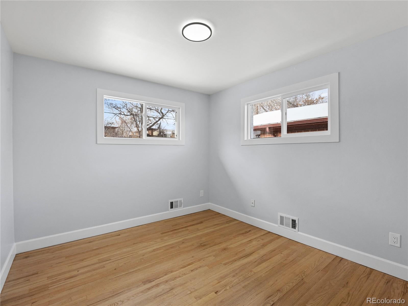 7889 North Pecos Street Denver, CO 80221 - Photo 26 of 42 an empty room with wooden floor and window