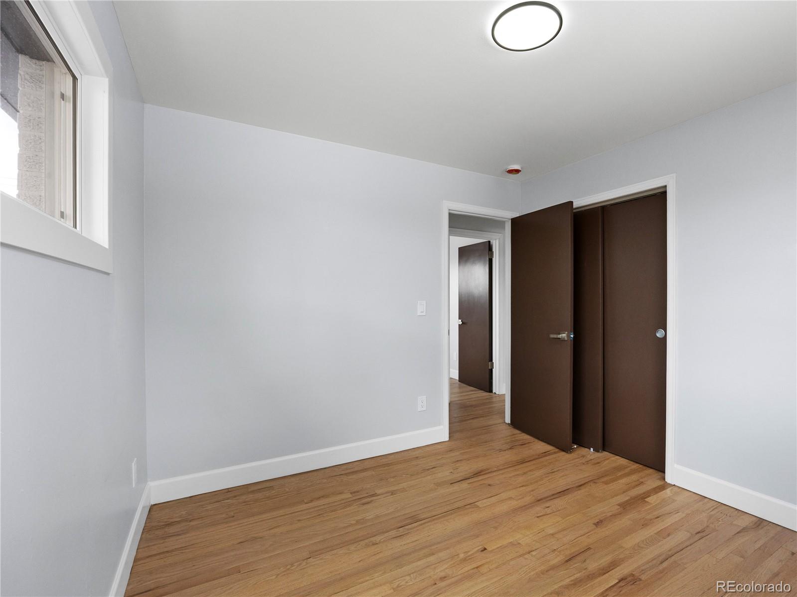 7889 North Pecos Street Denver, CO 80221 - Photo 27 of 42 a view of empty room with wooden floor