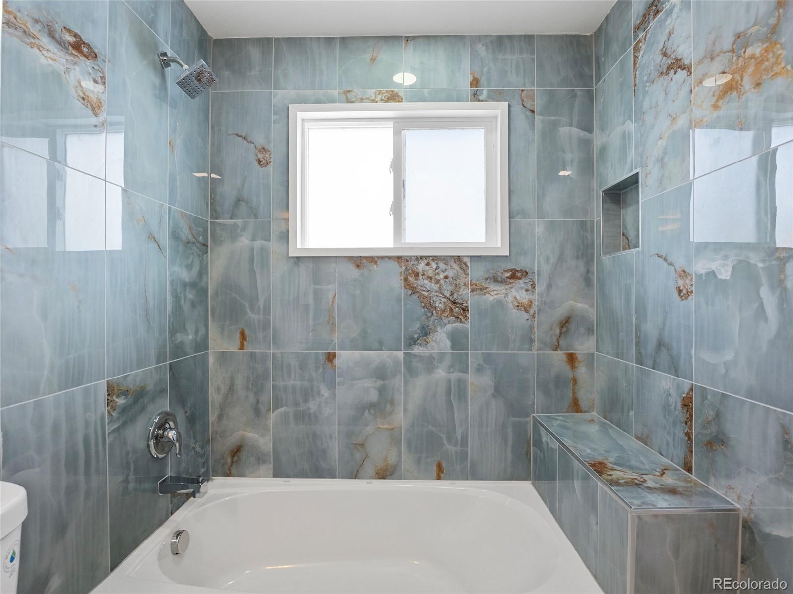 7889 North Pecos Street Denver, CO 80221 - Photo 29 of 42 a bathroom with a bathtub and shower