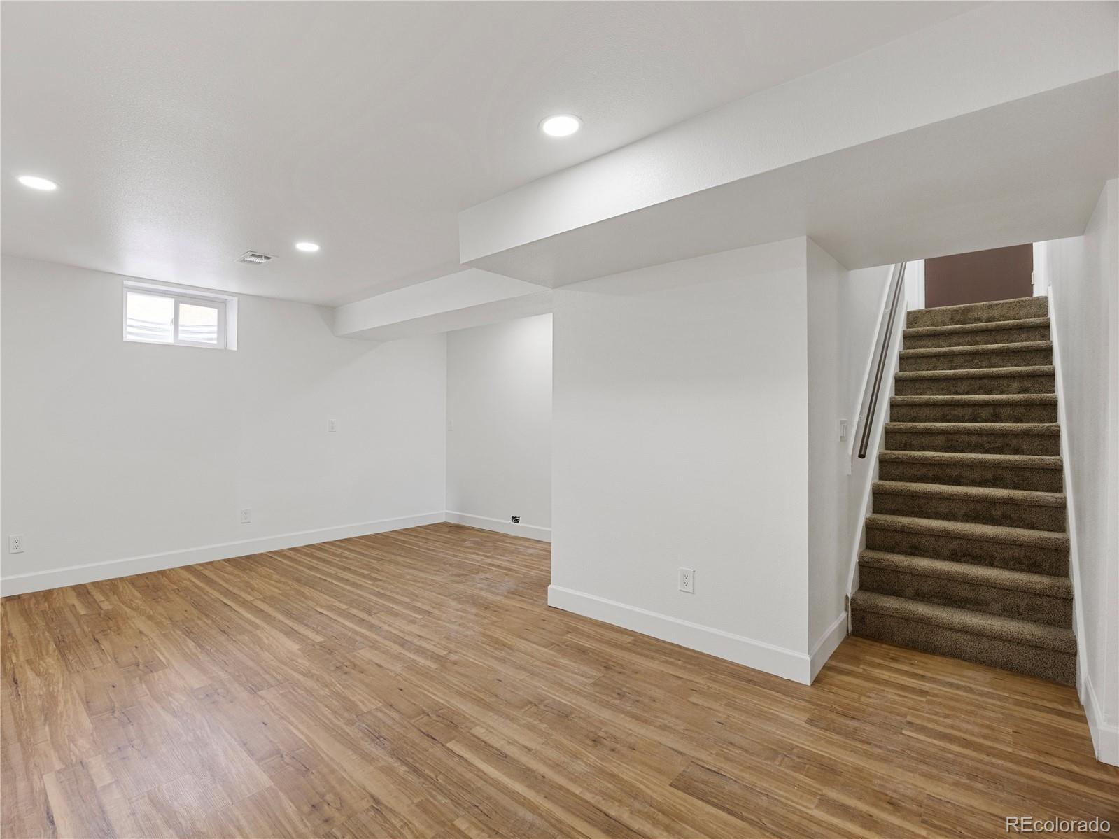 7889 North Pecos Street Denver, CO 80221 - Photo 30 of 42 a view of an empty room with wooden floor
