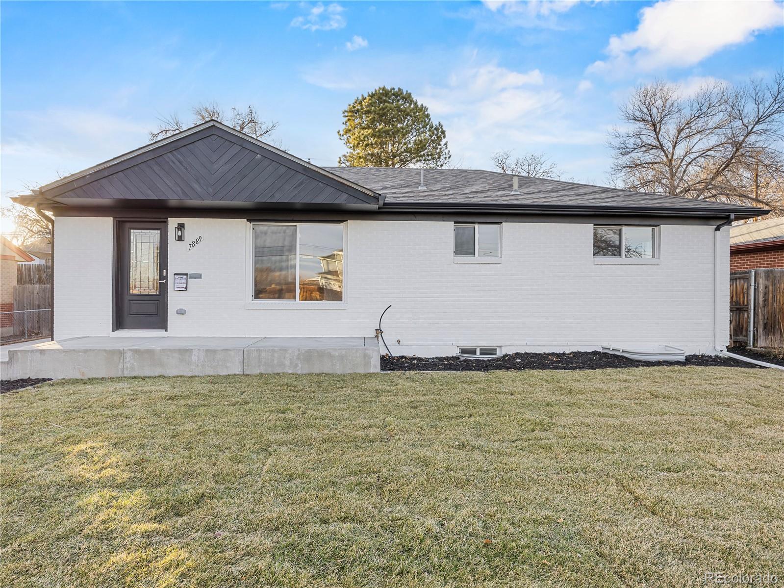 7889 North Pecos Street Denver, CO 80221 - Photo 3 of 42 a view of a house with a garden and yard