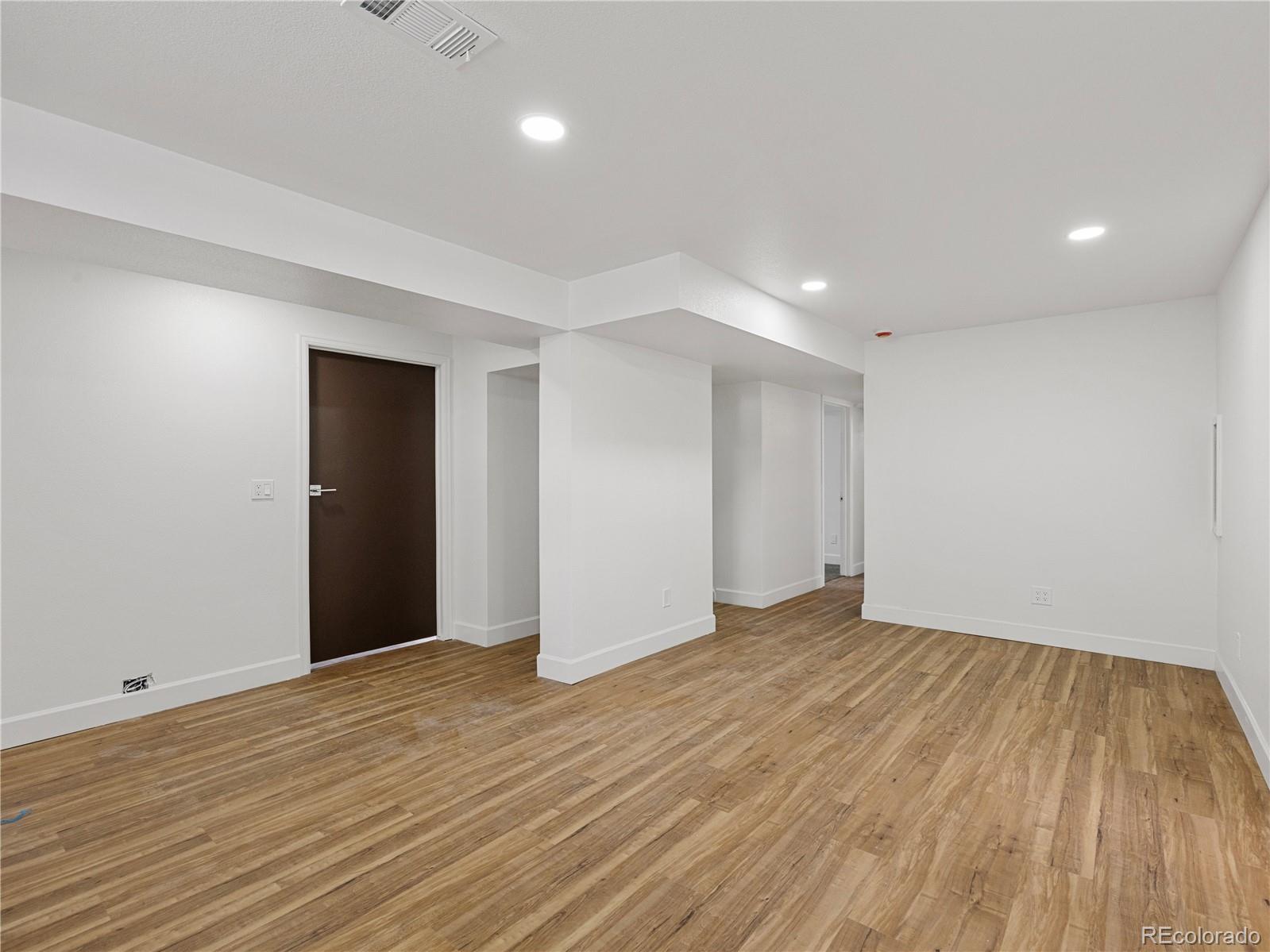 7889 North Pecos Street Denver, CO 80221 - Photo 31 of 42 a view of an empty room with wooden floor and closet