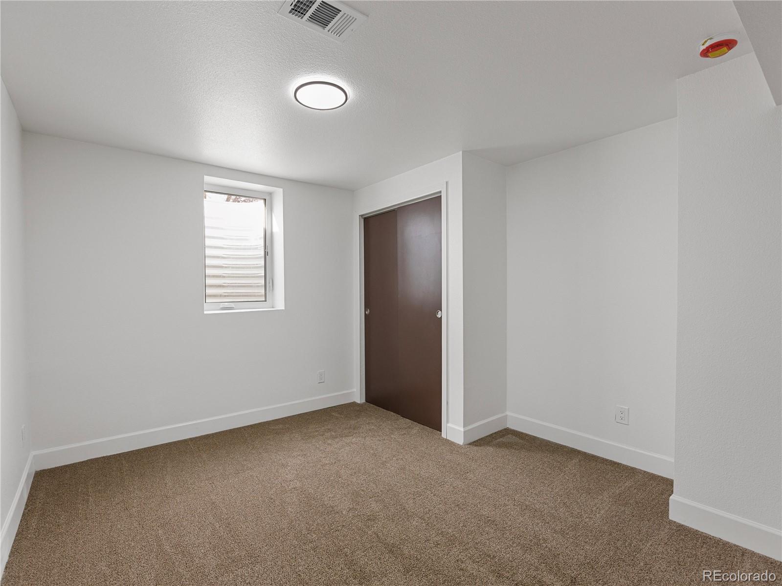 7889 North Pecos Street Denver, CO 80221 - Photo 34 of 42 an empty room with windows