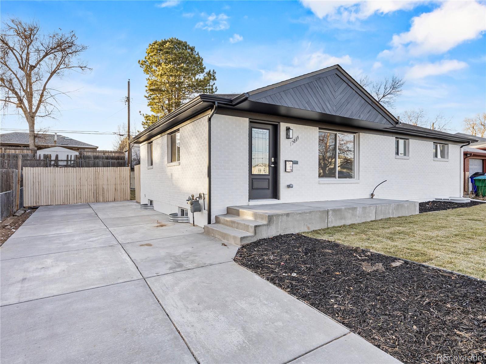 7889 North Pecos Street Denver, CO 80221 - Photo 5 of 42 a view of a house with backyard and trees