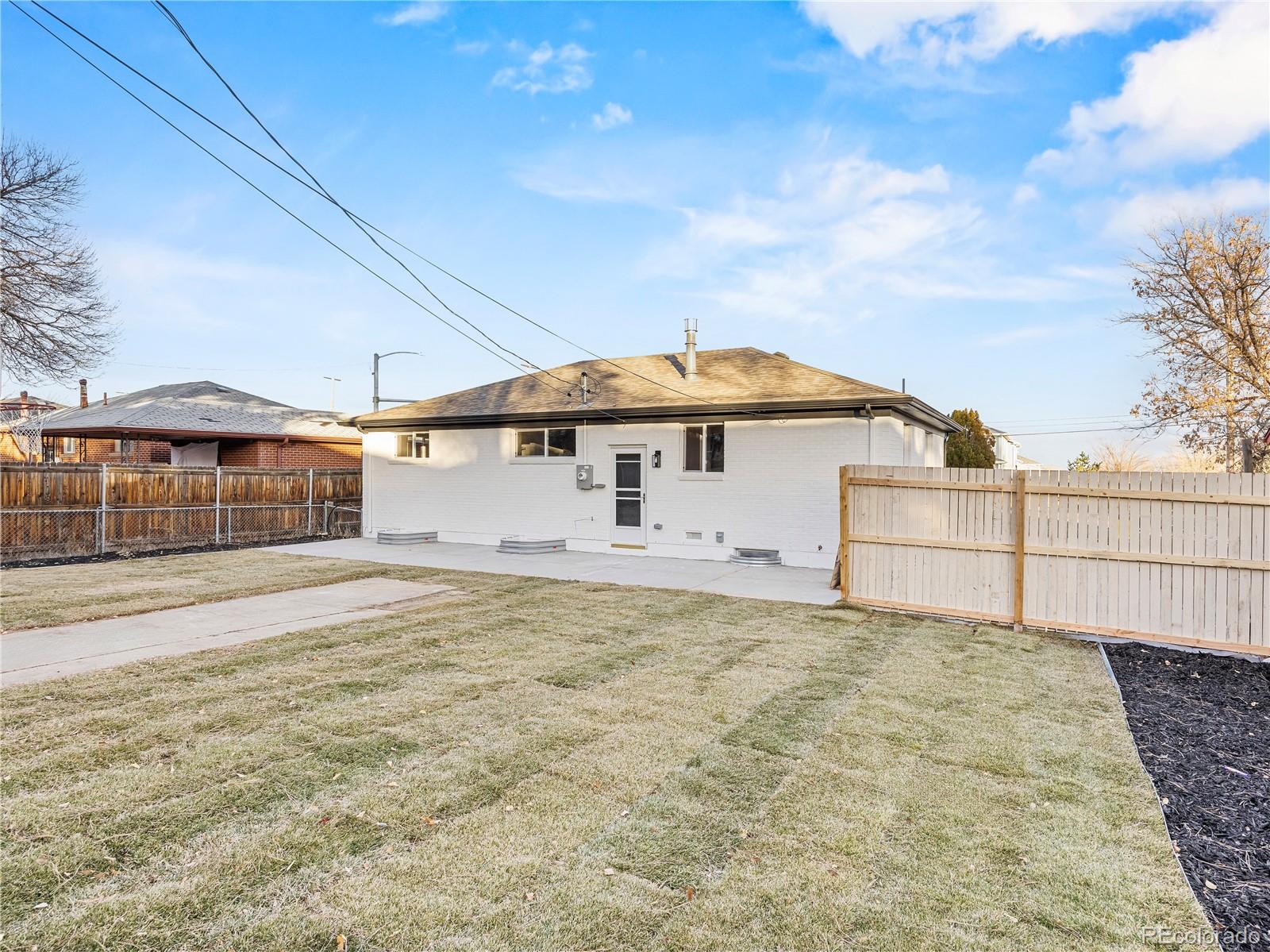 7889 North Pecos Street Denver, CO 80221 - Photo 8 of 42 a view of a house with backyard and wooden fence