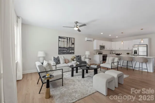 a living room with furniture dining table and a window