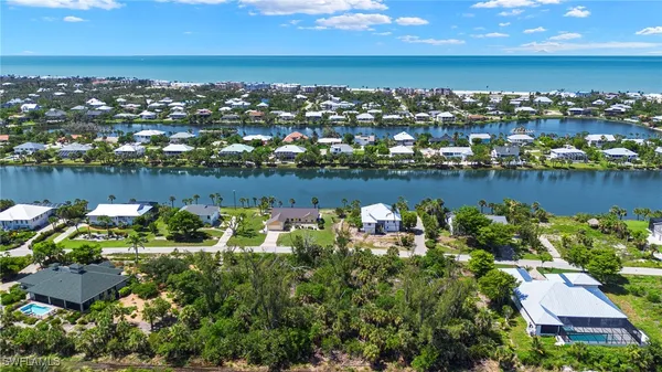 an aerial view of a houses with a lake view