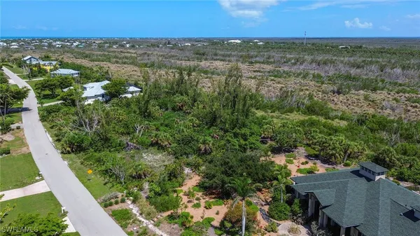 an aerial view of a houses with a yard