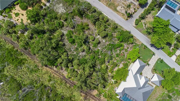 an aerial view of a residential houses with yard