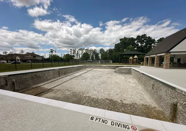 a view of swimming pool with a yard