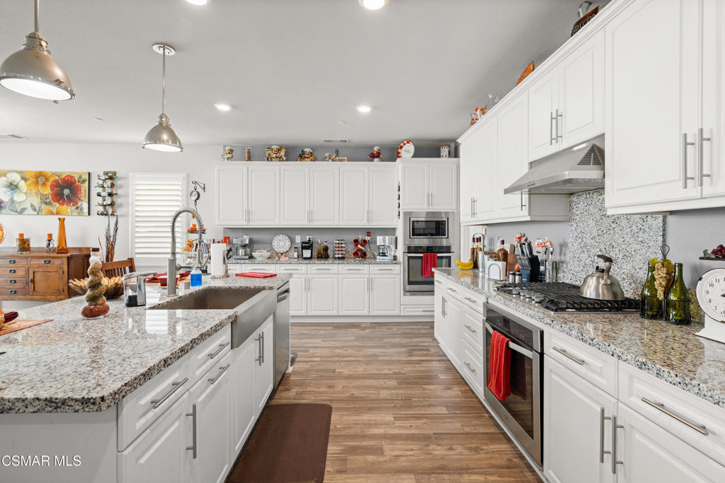 417 White Bark Lane Simi Valley, CA 93065 - Photo 13 of 30 a kitchen with stainless steel appliances granite countertop a sink stove and cabinets