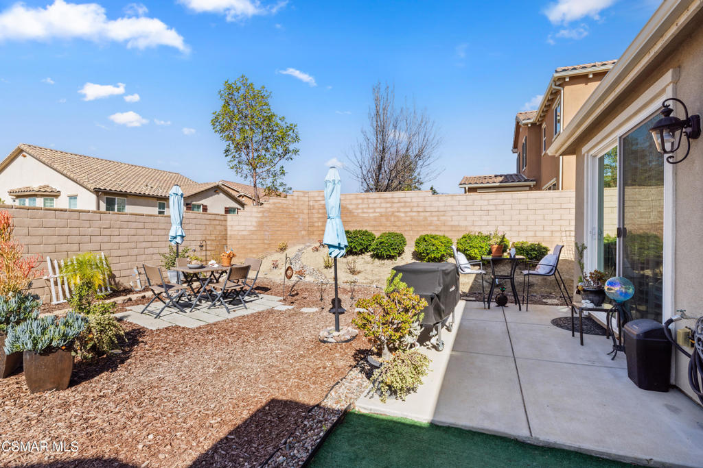 417 White Bark Lane Simi Valley, CA 93065 - Photo 26 of 30 a view of a patio with table and chairs and potted plants