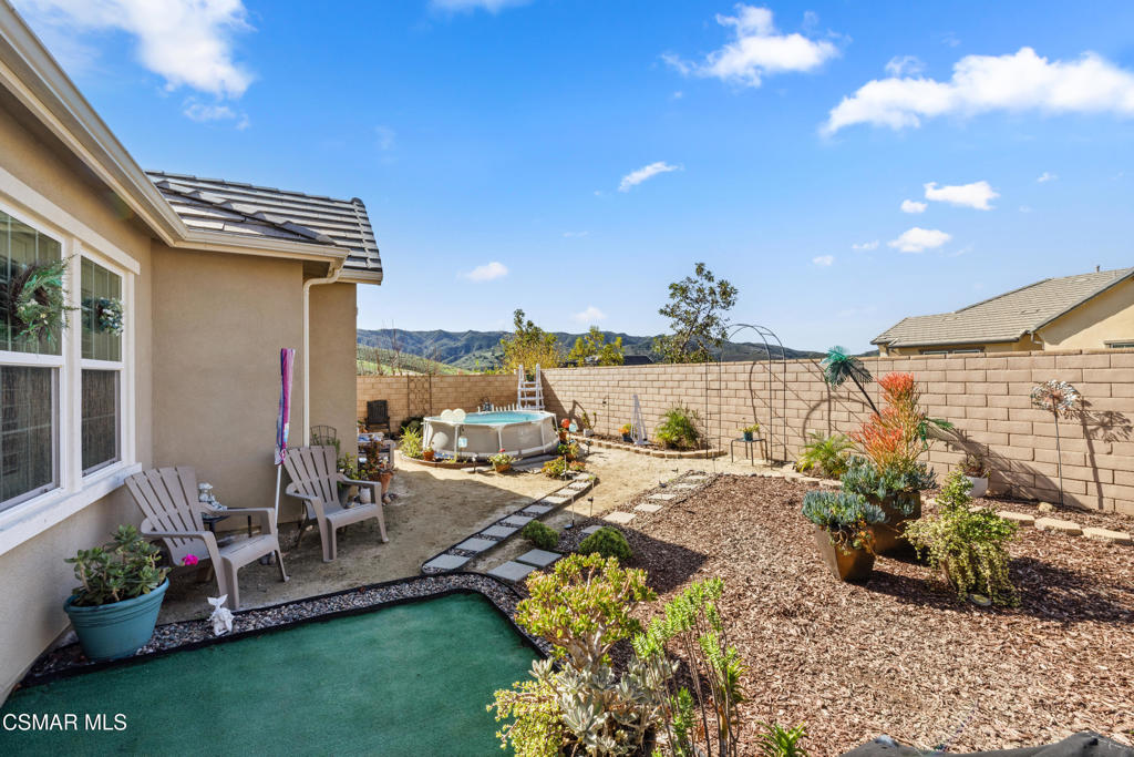 417 White Bark Lane Simi Valley, CA 93065 - Photo 27 of 30 a view of a backyard with plants and a patio