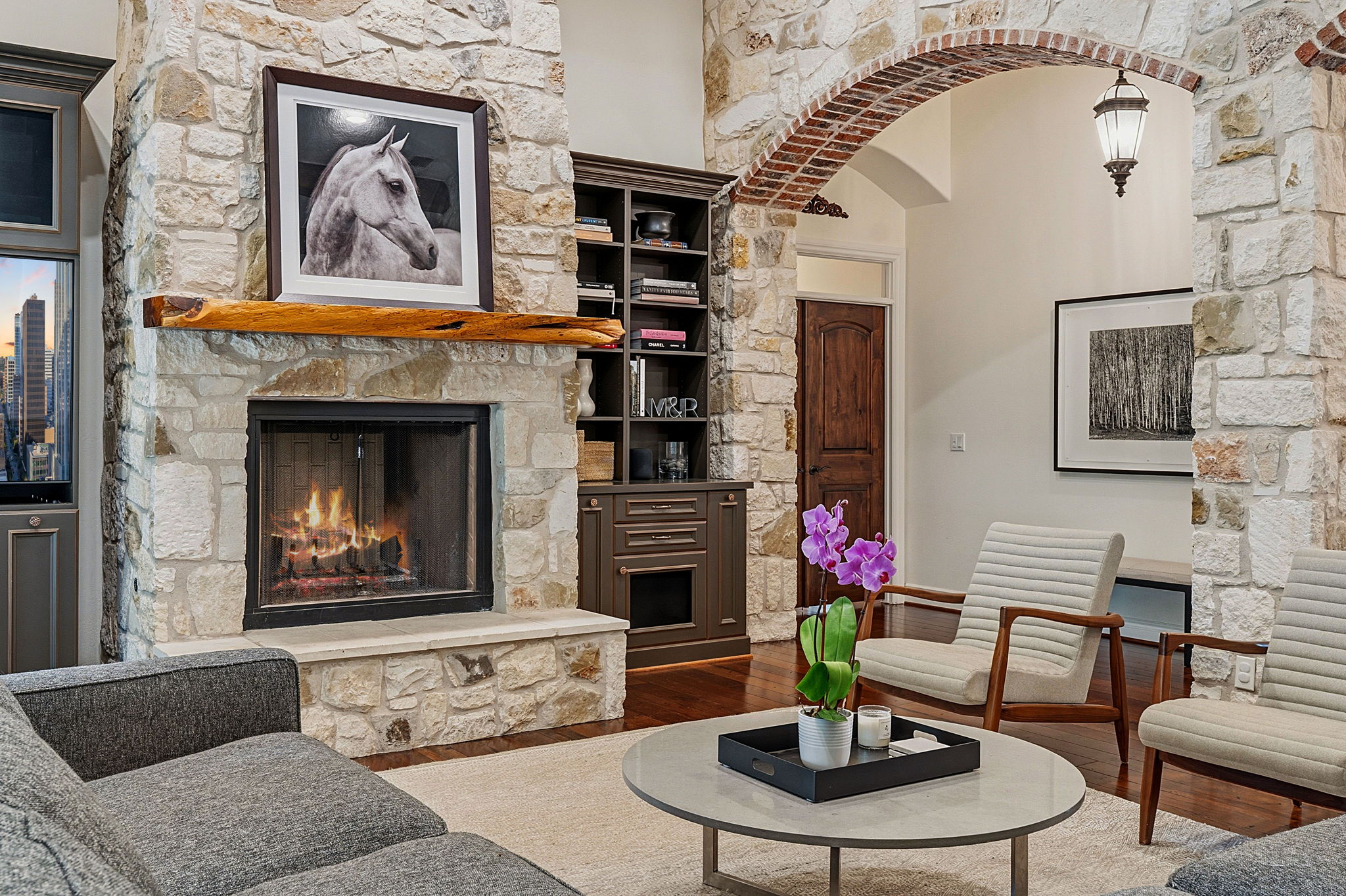 8121 Bluff Trail Austin, TX 78737 - Photo 14 of 40 A striking stone fireplace with a live-edge wood mantle anchors this inviting living space.