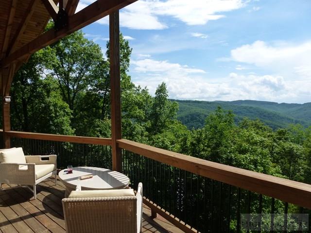 775 Miners Ridge Trail Banner Elk, NC 28604 - Photo 1 of 41 a view of a balcony with couches and wooden fence