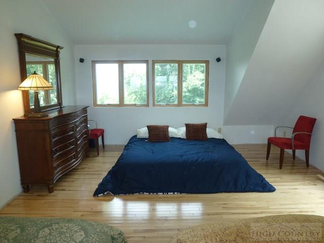 775 Miners Ridge Trail Banner Elk, NC 28604 - Photo 30 of 41 a bed sitting in a bedroom next to a window