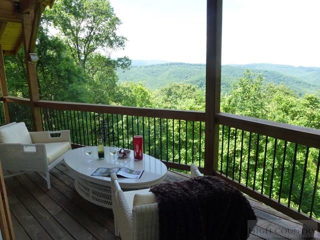 775 Miners Ridge Trail Banner Elk, NC 28604 - Photo 7 of 41 a view of a balcony with a table and chairs