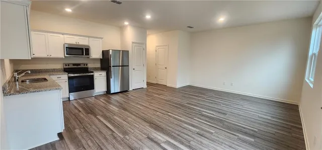an empty room with a wooden door and mirror