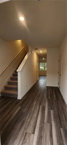 a view of a room with wooden floor