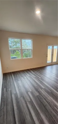 a kitchen with a refrigerator and white cabinets
