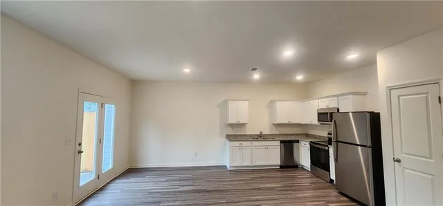 a view of a room with wooden floor and chair