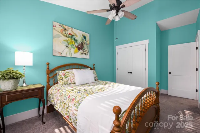 a bedroom with a bed and a chandelier