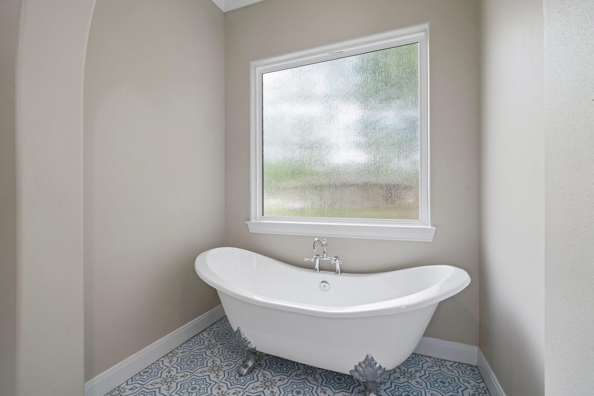 28526 Riverside Crest Lane Houston, TX 77336 - Photo 17 of 36 a white bath tub sitting next to a window