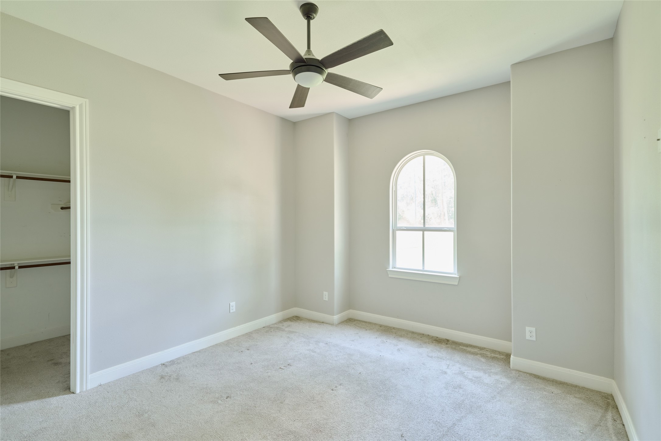 28526 Riverside Crest Lane Houston, TX 77336 - Photo 18 of 36 an empty room with a window and a fan