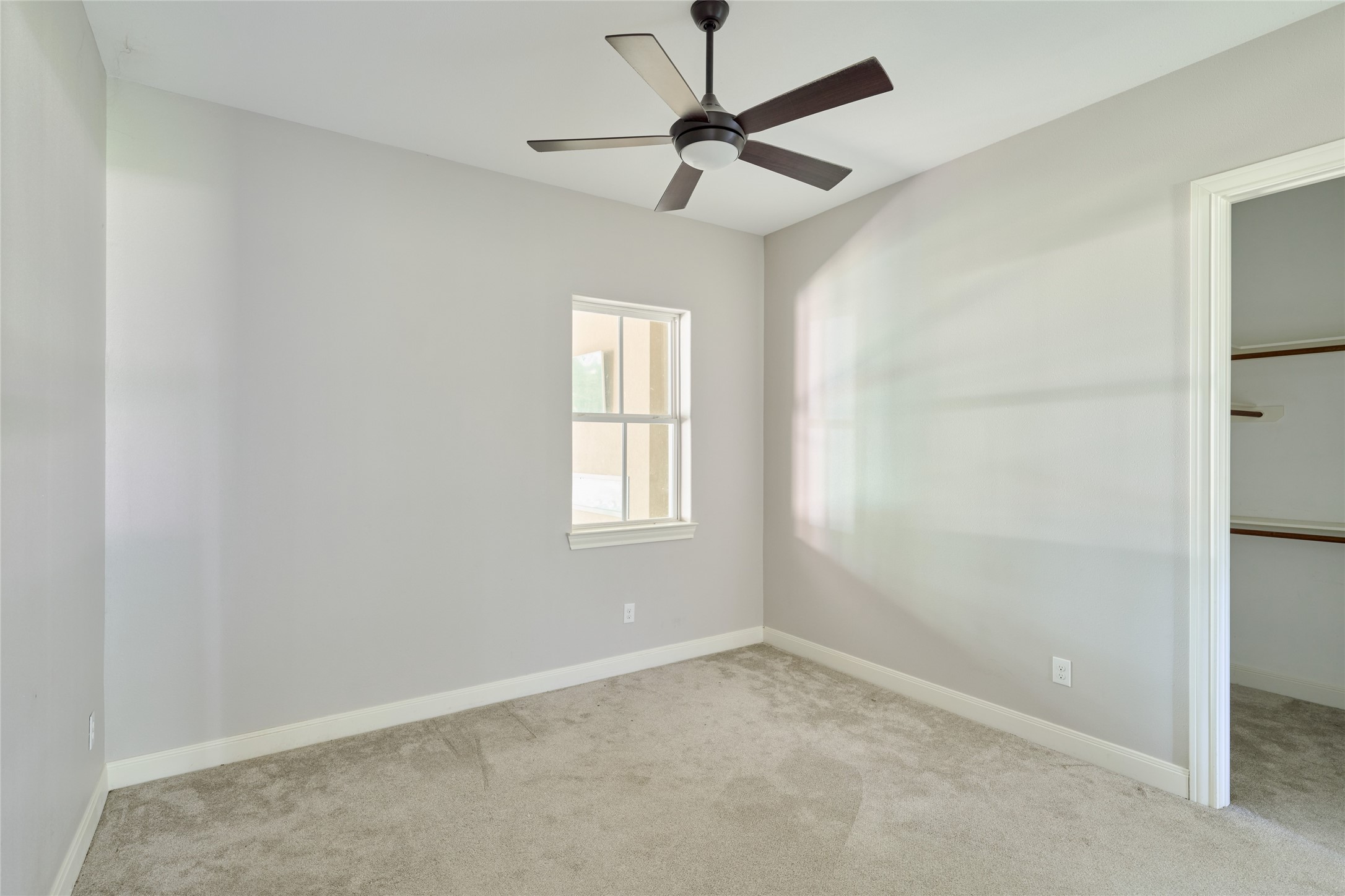 28526 Riverside Crest Lane Houston, TX 77336 - Photo 20 of 36 an empty room with a window and a fan
