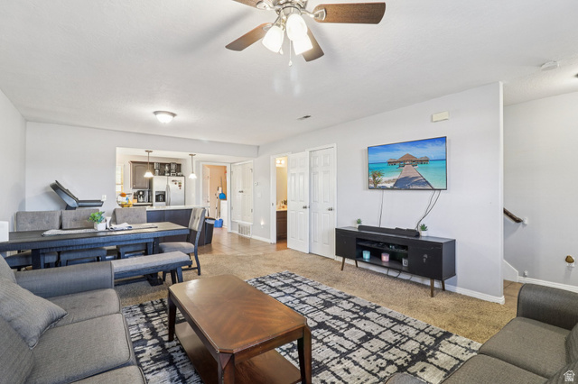1077 South 1850th Street West Springville, UT 84663 - Photo 6 of 22 Living area featuring a ceiling fan and light carpet