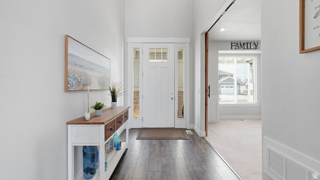 111 East Silver Oak Road Vineyard, UT 84059 - Photo 8 of 50 Inviting entryway featuring wood-finish flooring, a white front door with transom and sidelight windows, and light neutral wall paint