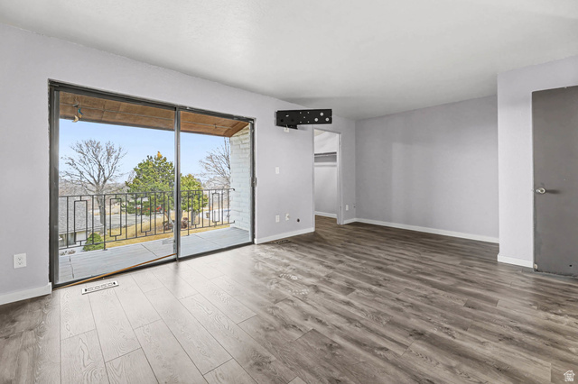34 Benchmark Village Tooele, UT 84074 - Photo 15 of 35 Unfurnished room with wood finished floors and baseboards