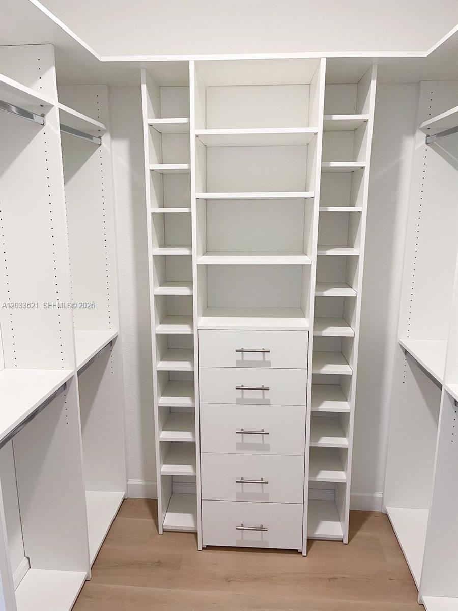 11942 Southwest 243rd Street Homestead, FL 33032 - Photo 21 of 50 a view of walk in closet with empty racks