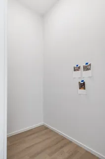 a view of a closet with wooden floor