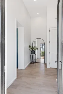 a view of a hallway with a potted plant