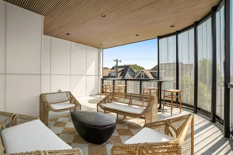 a view of a balcony furniture and rug