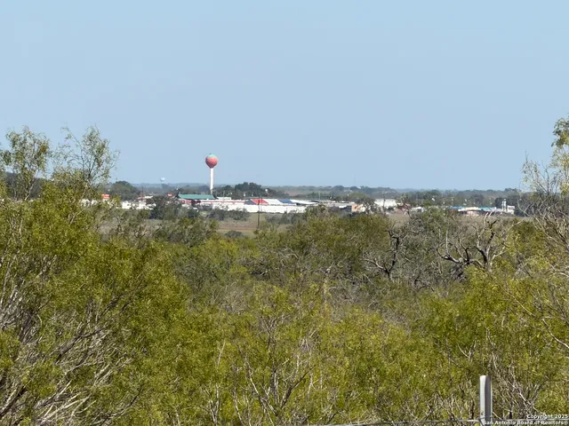 a aerial view of a houses with a yard