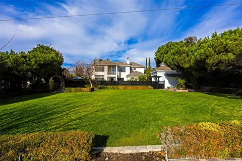 a view of backyard with swimming pool and outdoor seating