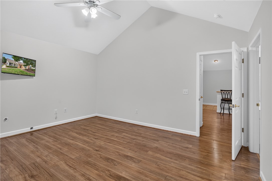 134 Life Style Lane Anderson, SC 29621 - Photo 12 of 44 Discover a spacious primary bedroom with soaring vaulted ceilings and rich hardwood flooring.