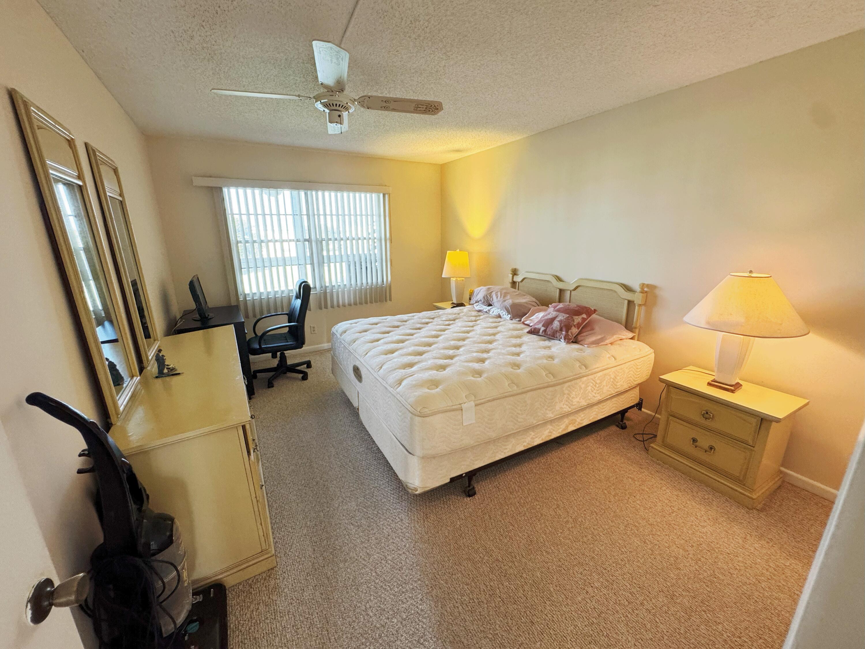4075 Cornwall East Boca Raton, FL 33434 - Photo 9 of 30 a bedroom with a bed flat screen tv closet and a large window