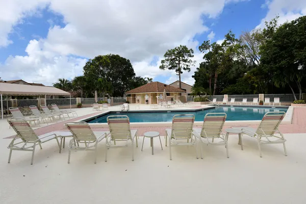 an aerial view of a house with a swimming pool yard and outdoor seating