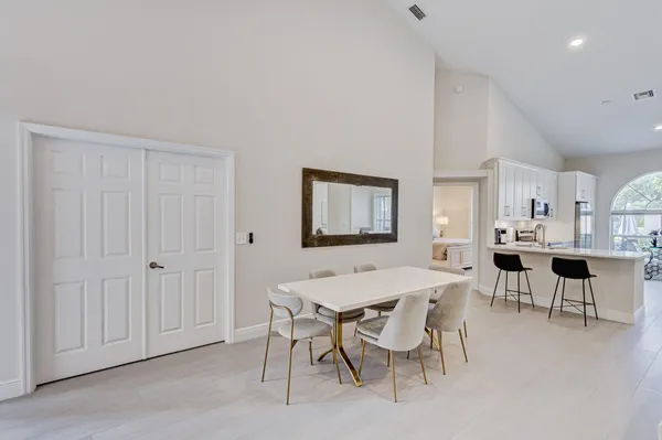 a view of a dining room with furniture and wooden floor